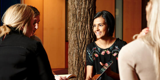 An indigenous staff member chatting with co-worker