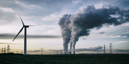Smoke stacks and wind turbine.