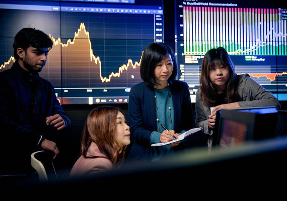 Students learning in Deakin's state-of-the-art trading room.