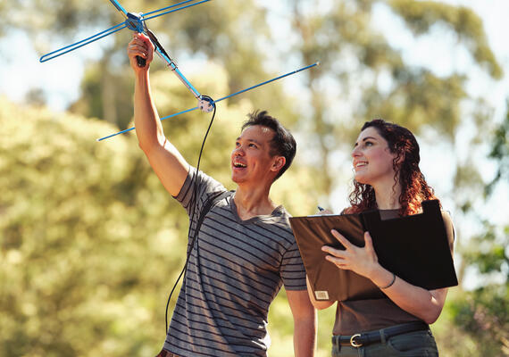 Deakin technology, science and health students performing an experiment outside.