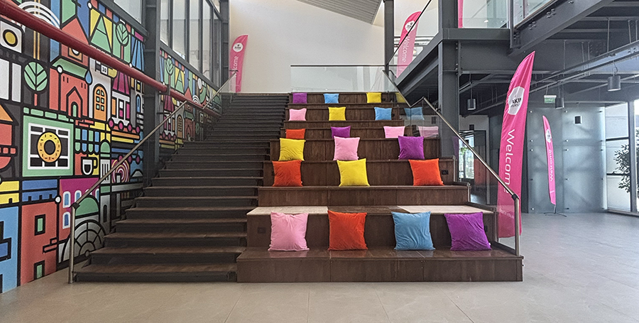 A set of stairs, with cushions for seating, at Deakin GIFT City campus