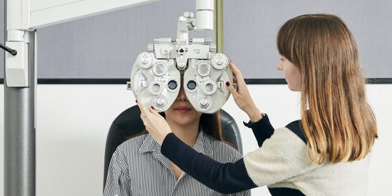 Optometry student with vision testing equipment - phoropter, Bachelor of Vision Science, Master of Optometry