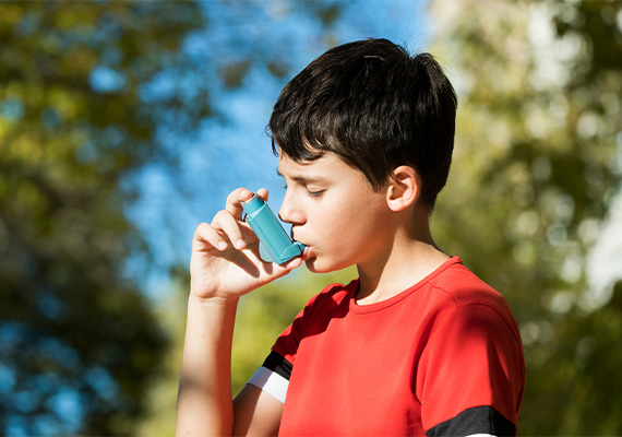 Boy uses asthma inhaler