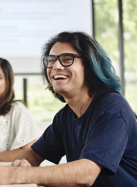 Students smile during a presentation in a criminology tutorial.