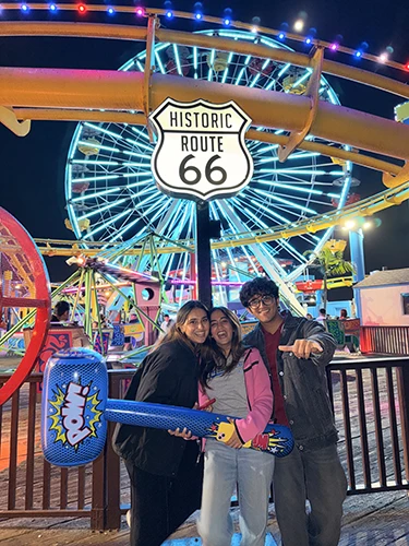 Tia and friends next to a Route 66 road sign