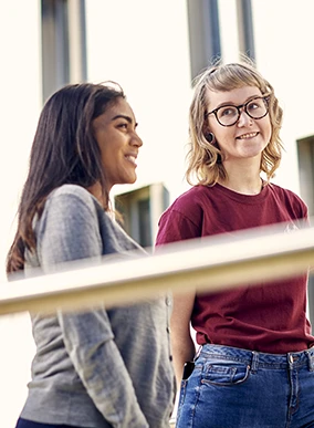 Two Deakin students chatting at the Geelong Waterfront Campus.