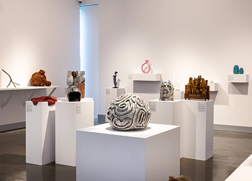 Installation image of the Deakin University Contemporary Small Sculpture Award 2026, featuring works (L-R) by; Sean Meilak, A Series of Transpositions; Katey Smoker, Persistence; Andre Sardone, Habitat for the locals; Pia de Bruyn, No Pride; Dónal Molloy-Drum, Haven Wall; Marija Patterson, I am so glad I left; De Lamby Wulff, Brainstorm; Laurel Kohut, One Last Embrace; Martin Moore, Bruiser; Brenda Page, Before Absence; Ian Munday, Making art…; Lucie Billingsley, Spores in Moonlight © and image courtesy of the artists. Photo by Fiona Hamilton.