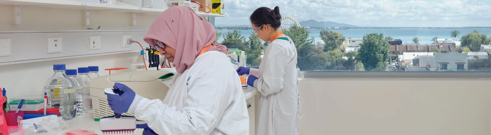 Two Deakin Master of Applied Science students work in a lab.