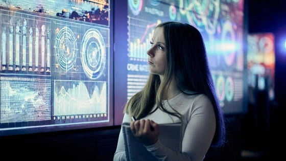 A postgraduate Deakin criminology student looks at data on a screen.