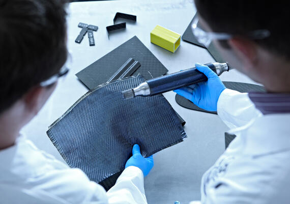 Researchers testing a blue fabric.