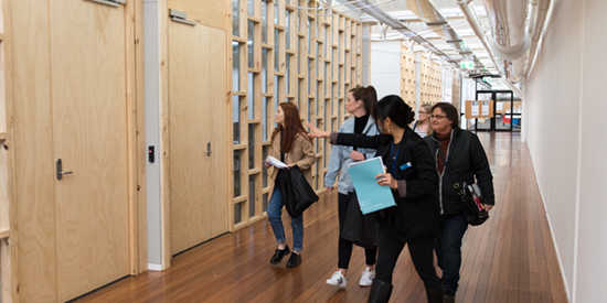 A tour of four females being shown around internal Deakin facilities