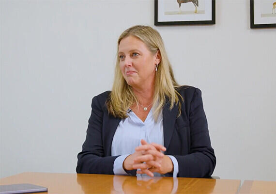 Kate Clarke MBA Alum sitting at a table in a conversation