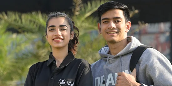 Two deakin university students from the India GIFT campus smiling together on campus.