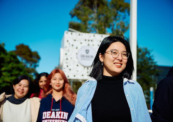 Group of international students on campus, walking outside.