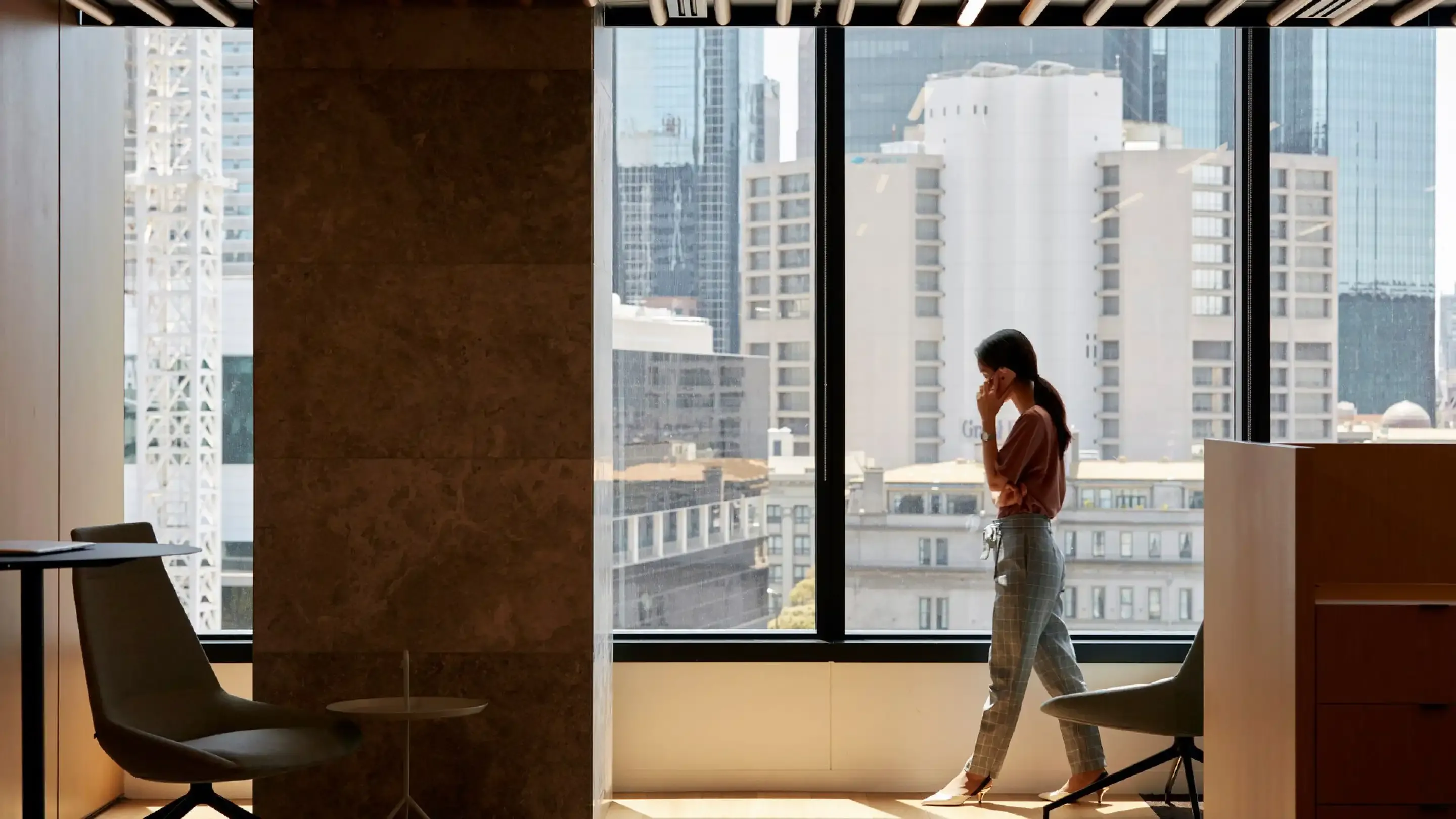 Person standing in front of window in corporate building