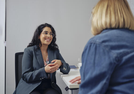 A health professional sits across from a patient for an appointment.