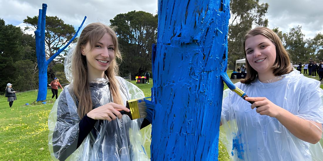 Students paint a tree blue at the Waurn Ponds Campus