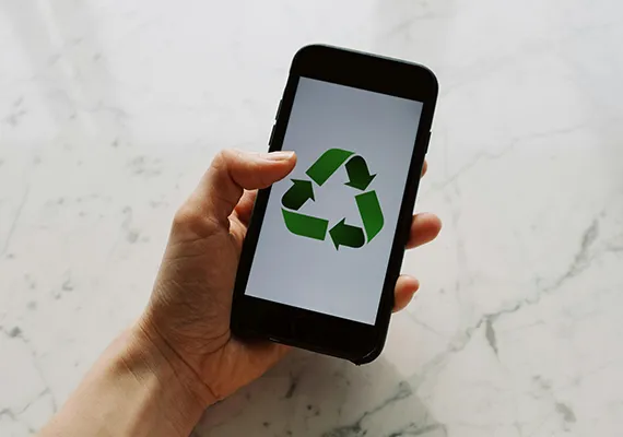 Mobile phone with a sustainable logo on it.