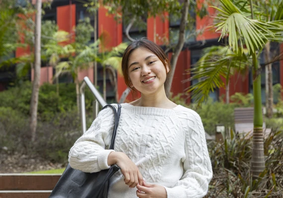 A Deakin international student smiles at the camera