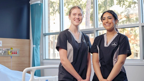 Nursing students in hospital ward.