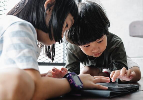 Children with tablet device.