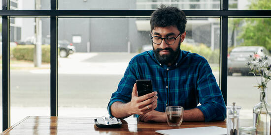A Deakin student in a cafe