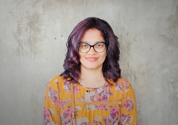 A headshot of Shilpa Sawant wearing an orange floral top.