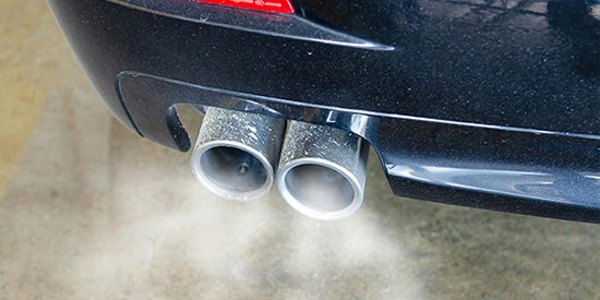 A car exhaust emitting fumes. 