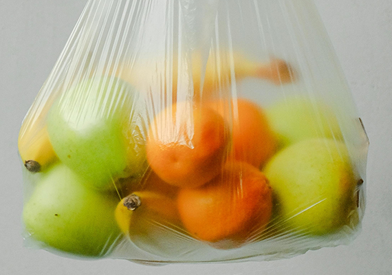 A clear bag holding a variety of fruit