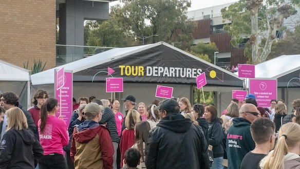 A group of students outside at Open Day waiting for tour departures