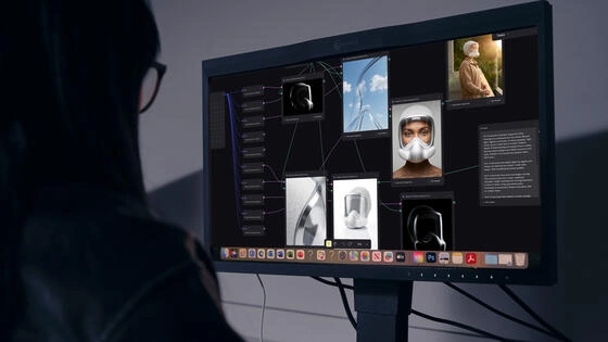 Silhouette of a Master of Artificial Intelligence for Design and Creative Practice student using AI on a computer screen.