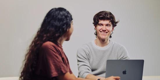 Two Deakin undergraduate students study and socialise on campus