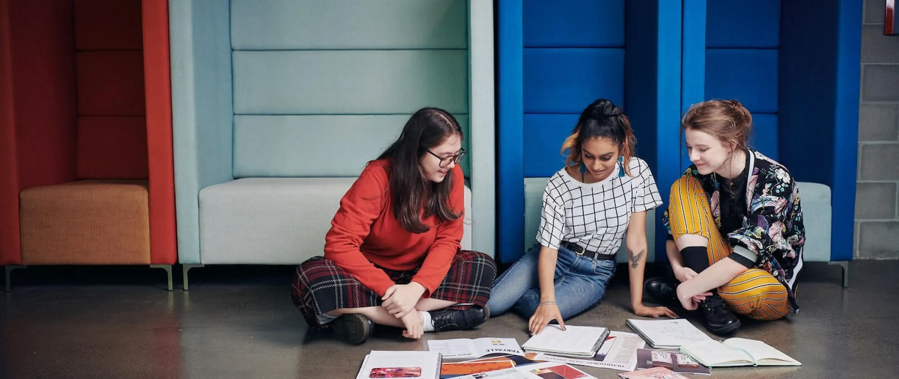 Three student crossed legged