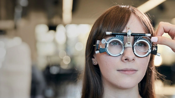Optometry student with vision testing equipment