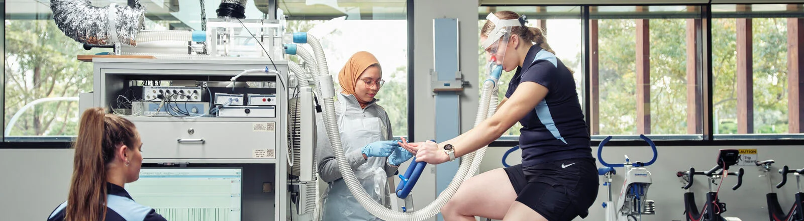 Deakin Master of Applied Science Health students monitor a person on an exercise bike.