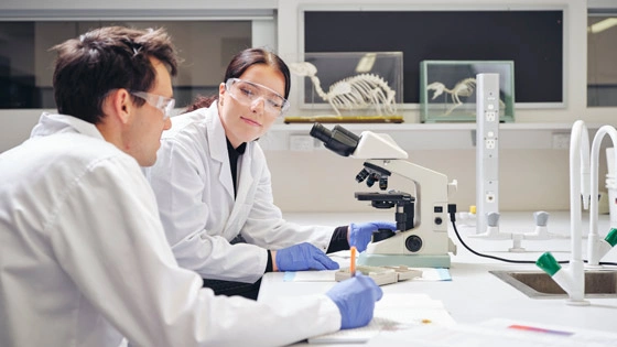 Students looking through microscope.