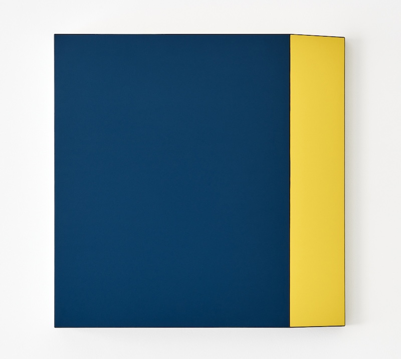 59286_800x717_suzie_Idiens_artwork.jpg Abstract artwork featuring two blocks of highly saturated colour, with a dark blue to the majority of the left of the surface and yellow to the right of the surface, creating a horizontal stripe of yellow. The top and the bottom of the yellow stripe appears tapered inwards.