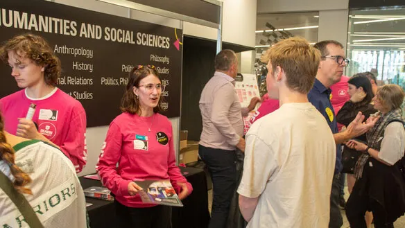 Students talking with staff at an open day event