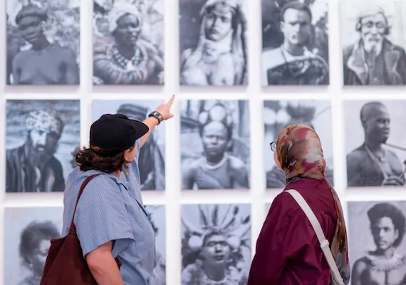 Two study abroad and exchange students looking at an art display.