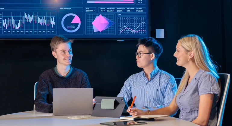 Students discussing business data.