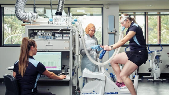 Deakin Master of Applied Science Health students monitor a person on an exercise bike.