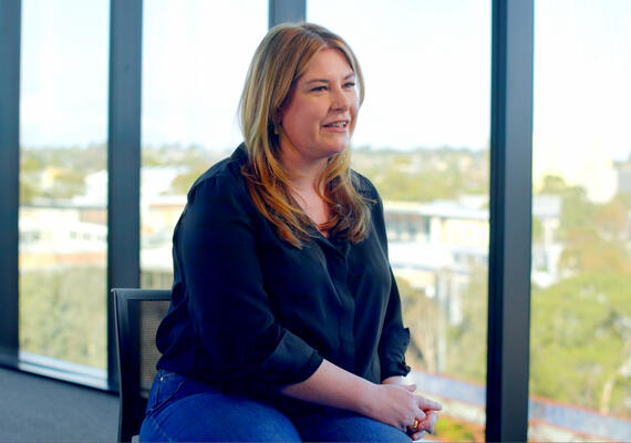 MBA Alum Melanie sitting near window