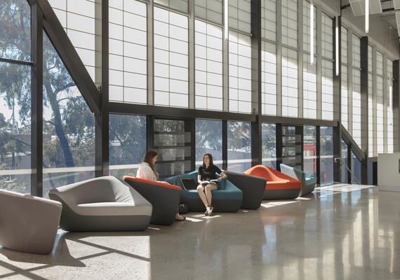 Students sit and talk inside CADET building