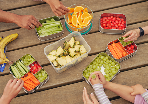 A selection of healthy fruit and vegetables on a table outside