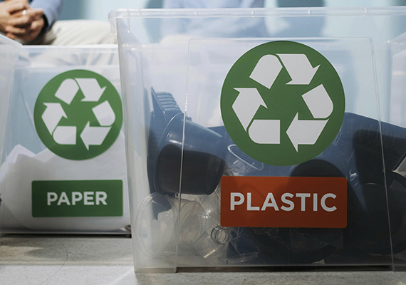 Two tubs holding paper and plastic recycling