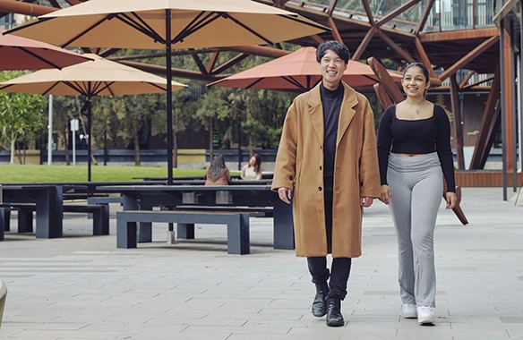 Two Deakin students walking outside.