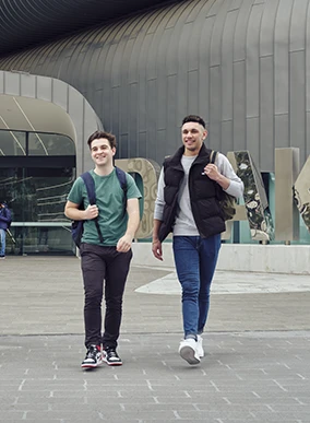 Two Deakin students walking at the Melbourne Burwood Campus.