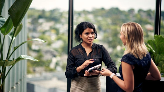 Two business students talking in a building