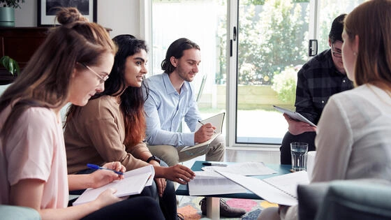 A group of Deakin postgraduate international relations students talk.