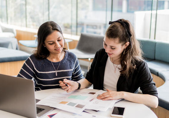 Two Deakin students collaborating in study space.